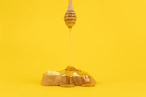 Honey dripping on bread. Stock Photos