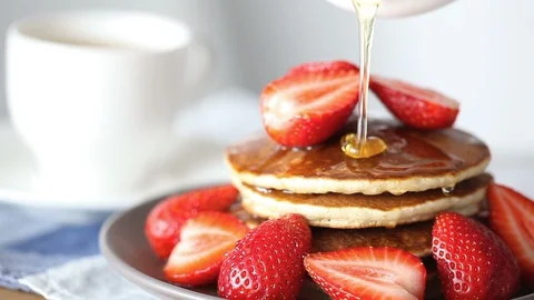 Honey dripping down a pancake stack and strawberry. Stock Footage 90415169