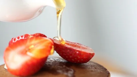 Honey dripping down a strawberry. Stock Footage 90415865