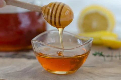Honey dripping in the hand Stock Photos