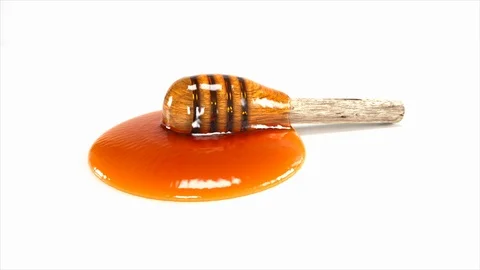 Honey dripping isolated on a white background, Look delicious. Video stock 125189751