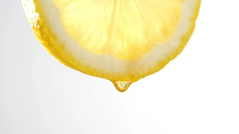 Honey dripping from slice lemon in slow motion on white background Stock-Footage 126953229