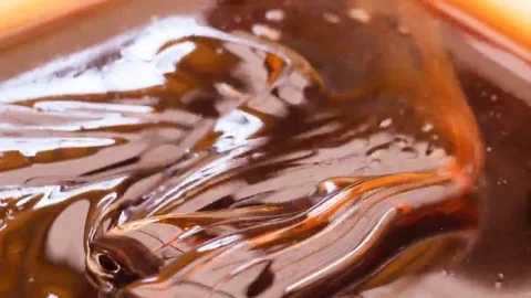 Honey dripping from a spoon Stock Footage 69125536
