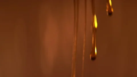 Honey drops falling in slow motion 4K Stock Footage 220612714