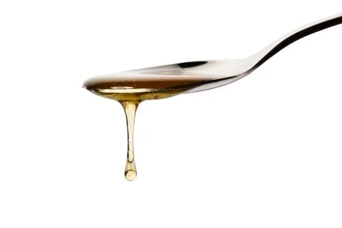 Honey drops from a spoon Stock Photos