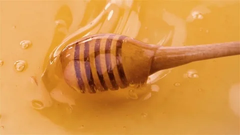 Honey extraction with a dipper in slow motion Stock Footage 74760473