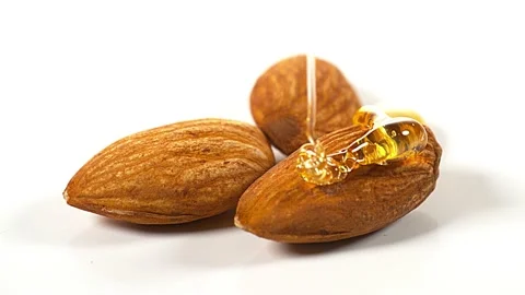 Honey flowing on almonds Stock Footage 229404898