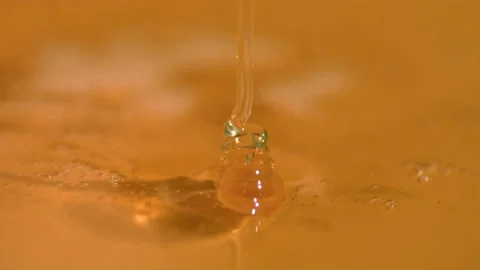 Honey flowing in slow motion; closeup 4k footage Stock Footage 201112054