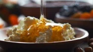 Honey Flows On Cottage Cheese For Breakfast Stock Footage
