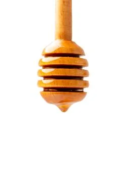 Honey flows down from a dipper close-up on isolation with space for text. Stock Photos