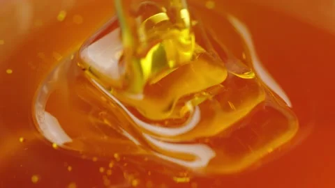 Honey flows down on the honey in a thick stream Stock Footage 161077221