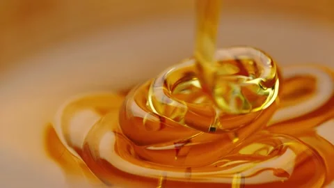 Honey flows down on the honey in a thin stream Stock Footage 161077226