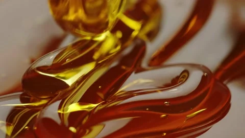 Honey flows down in a thin stream on the honey in a dark place. close-up Stock Footage 161077219