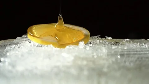 Honey flows into lemon Stock Footage 85395000