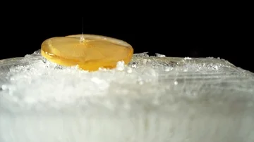 Honey flows on a lemon on ice Stock Footage 85860313