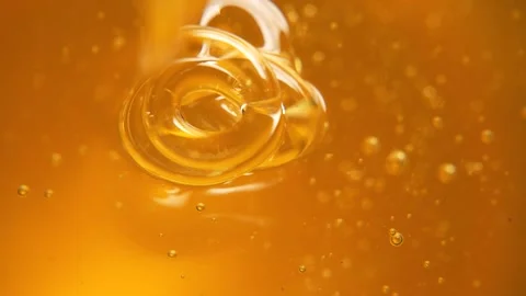 Honey flows in thin curls. Сlose-up honey background Video stock 290553269