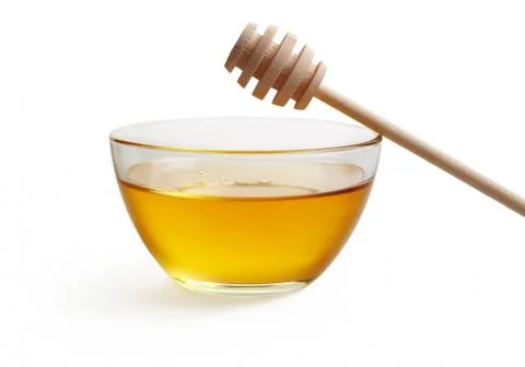 Honey in glass bowl Stock Photos