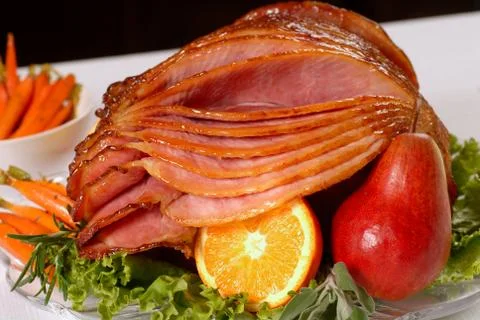 Honey glazed easter ham with fruit and carrots Stock Photos