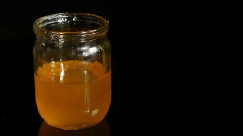 Honey jar on a black background Stock Footage 85194093