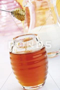 Honey jar, honey dripper Stock Photos