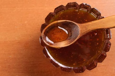Honey in a jar on the kitchen table Foto stock