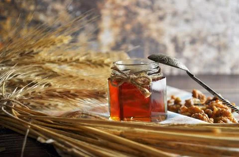 Honey in jar with spoon. Stock Photos
