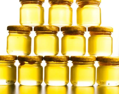 Honey jars pattern over white background forming a pyramide. 写真素材