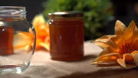 Honey jars of rustic production, thick golden honey dripping in glass bowl 스톡 동영상 128159012