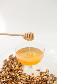 Honey natural with a wooden spoon on a white background Stock Photos