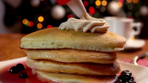 Honey or maple syrup pouring onto pancakes. Easy morning breakfast concept. Stock Footage 336589043