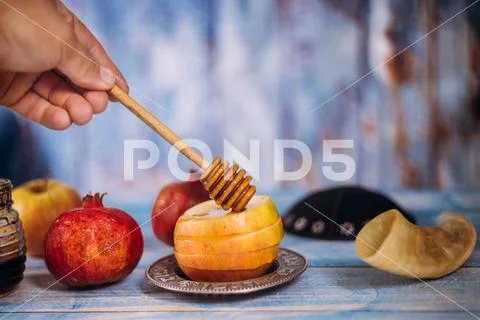 Honey on the pomegranate and apples. Jewish new year Yom Kippur and Rosh Hash Stock Photos