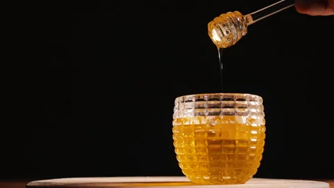 Honey pot with black background Stock Footage 166067852