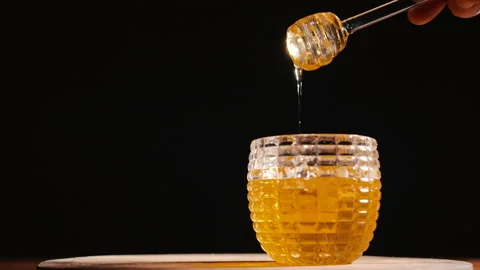 Honey pot with black background Stock Footage 166067879