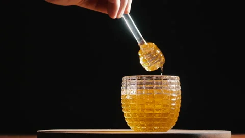 Honey pot with black background Stock Footage 166067927