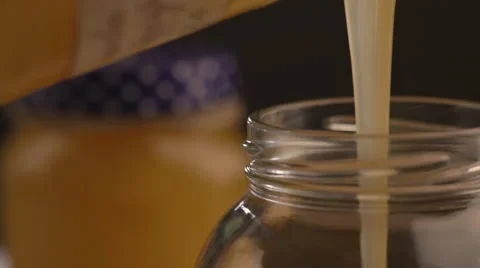 Honey is poured into the can Stock-Footage 67888801