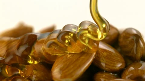 Honey pouring on almond, Slow Motion Stock Footage