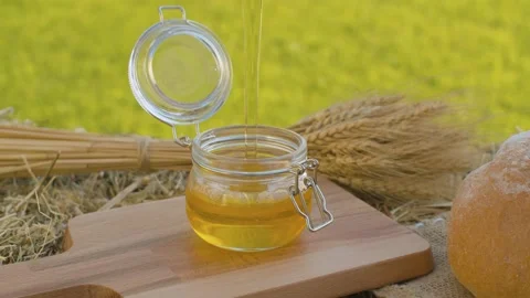 Honey pouring into a jar Stock Footage 139651632