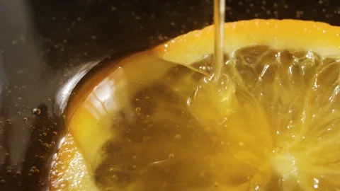 Honey pouring on a lemon, a slice of lemon with honey, background video with  Stock Footage 129167488