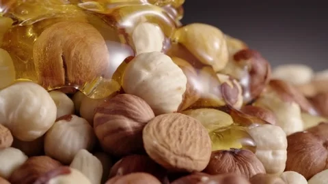 Honey pouring on nuts Stock Footage 130876551