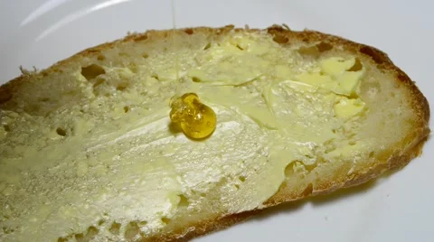 Honey running on a bread Stock Footage 44352486