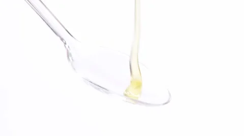 Honey running onto plastic spoon Video stock 8571611