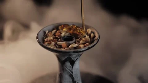Honey slowly poured on nuts. Hookah bow Stock Footage 198179409