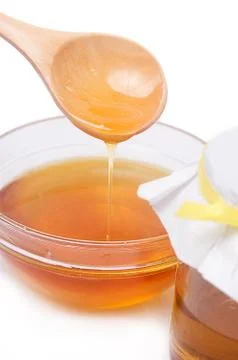 Honey in spoon Stock Photos
