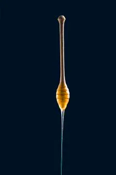 Honey stick on black background Stock-Fotos