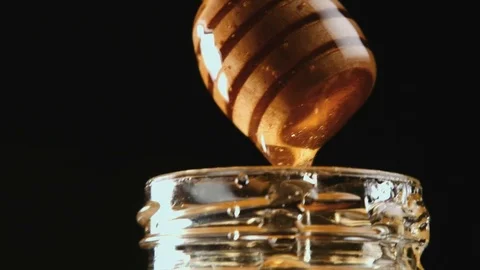 Honey stick getting out of jar Video stock 69996986