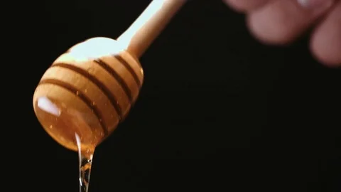 Honey stick getting out of jar Stock Footage 69997508