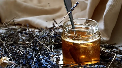 Honey stirred in jar Stock Footage 128703471