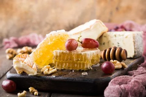 Honeycomb with assorted cheeses Stock Photos
