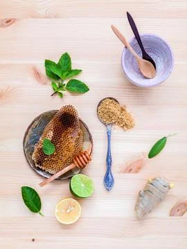 Honeycomb on ceramic plate with peppermint ,lime lemon,ginger and sage set .. Stock Photos
