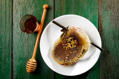 Honeycomb on white dish Stock Photos